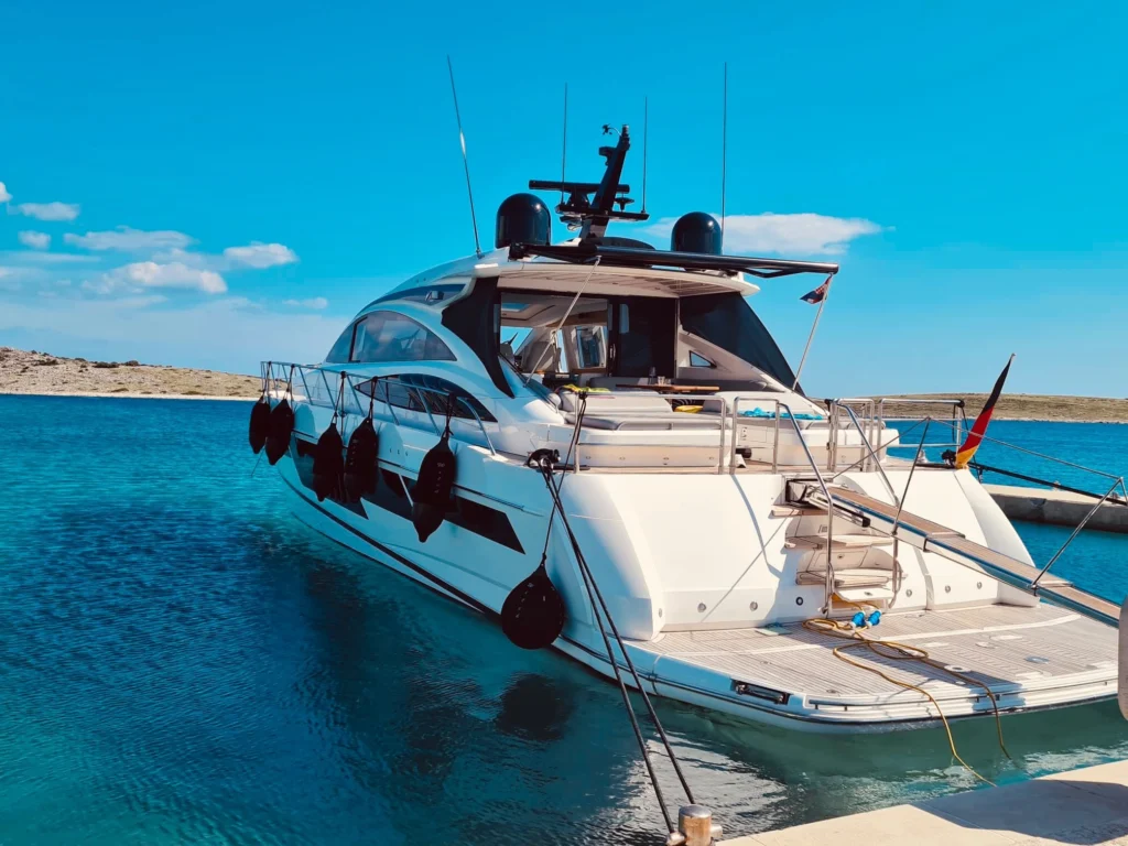 Stern and cockpit of the Princess V70, moored in clear turquoise water