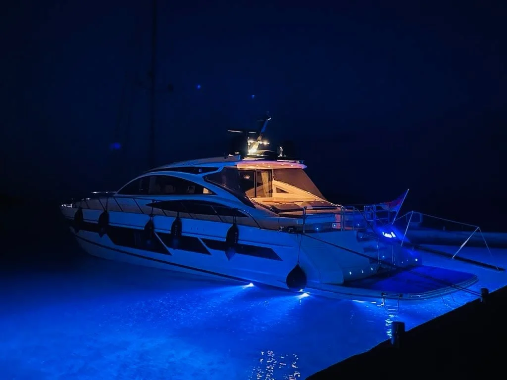 Princess V70 at night with underwater lights on