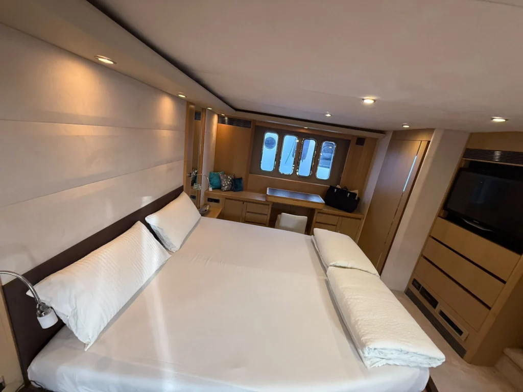 Master stateroom double bed and hull windows